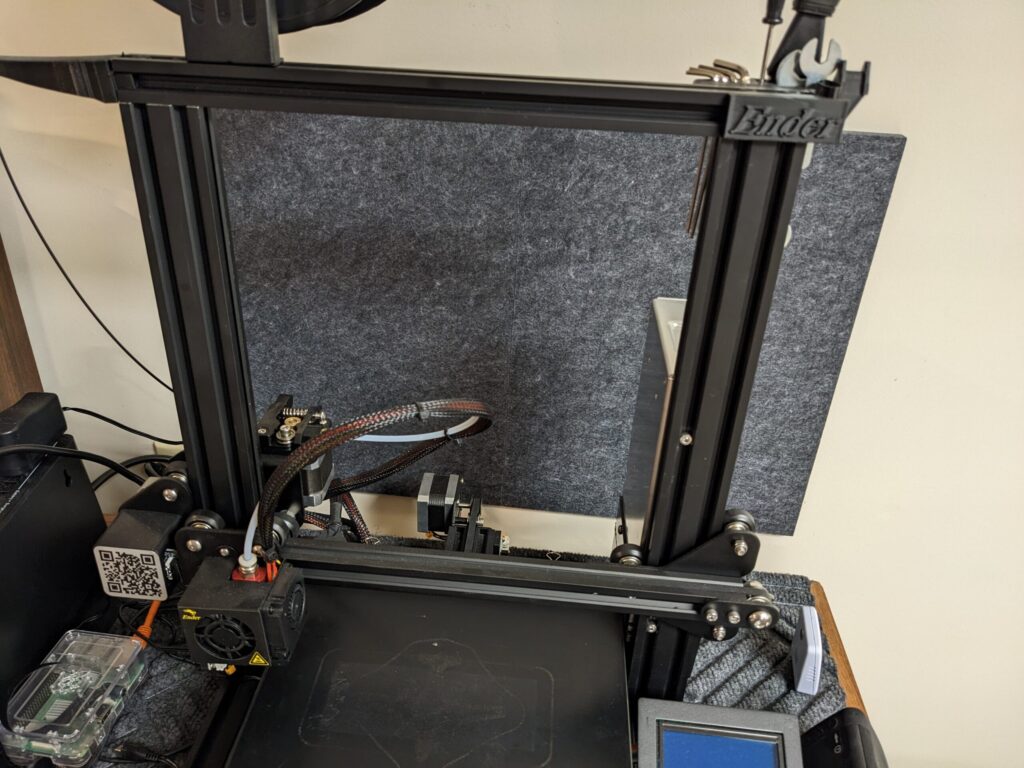 Acoustic panels behind Ender 3D printer which is sitting on top of a rug