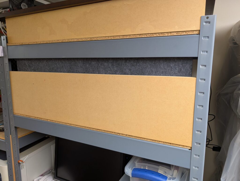 MDF piece wedged in to hold panels and provide more mass