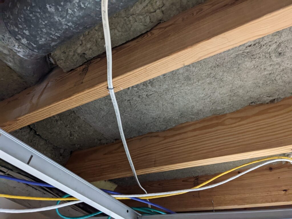 Rockwool installed between the floor joists above my basement's suspended ceiling.
